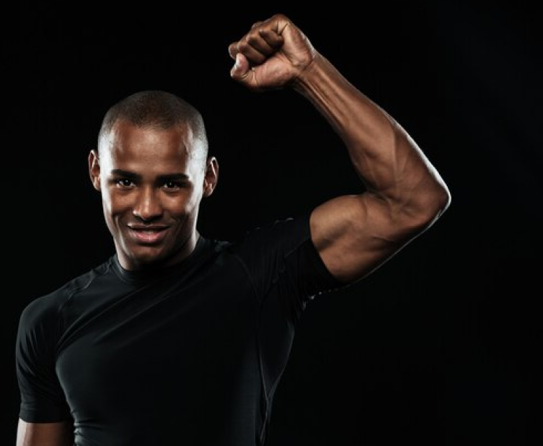 Young happy afro american sports man celebrating his victory with raised arm
